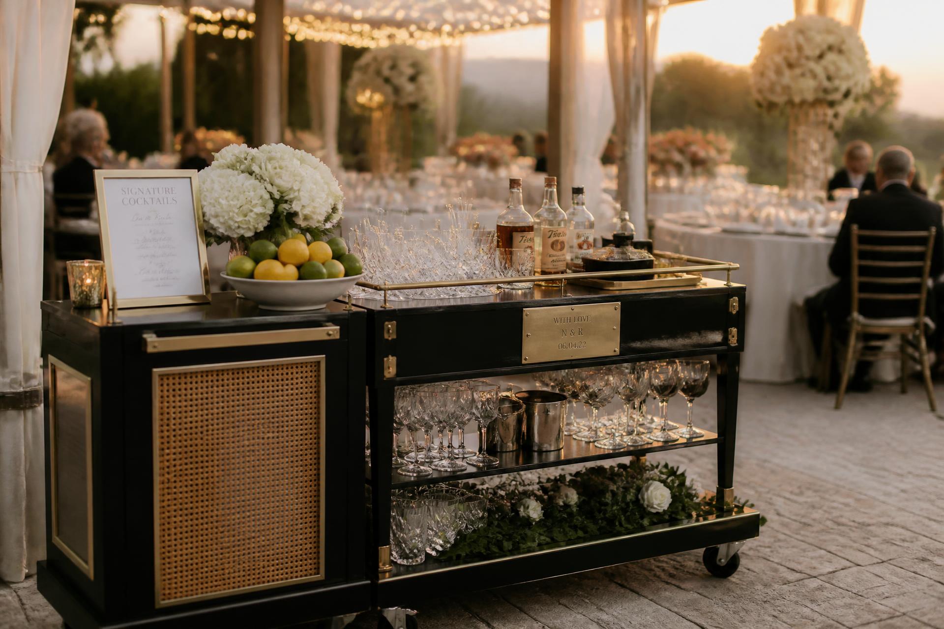 An elegant Cap & Co. mobile bar styled for an outdoor celebration at golden hour